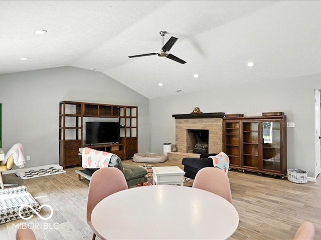 11093 N Pheasant Run, Fairland, IN 46126 - living room with light wood-style flooring, vaulted ceiling, ceiling fan, recessed lighting, and a brick fireplace