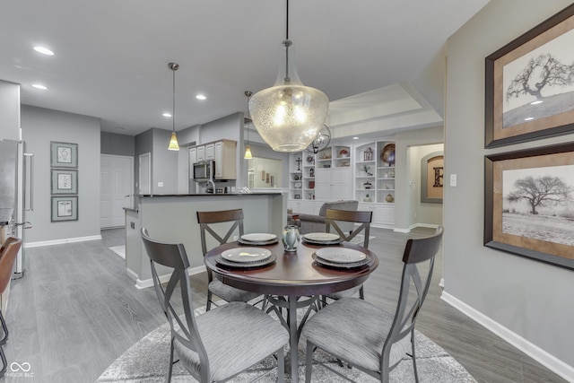 1454 Heron Ridge Blvd, Greenwood, IN 46143 - dining room featuring wood finished floors, built in shelves, and recessed lighting