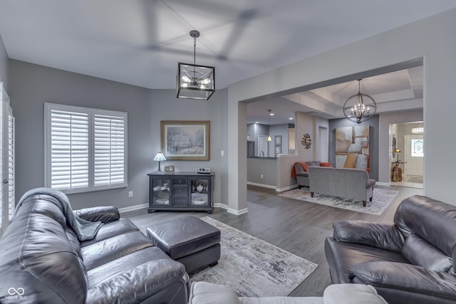 1454 Heron Ridge Blvd, Greenwood, IN 46143 - living area with a chandelier, healthy amount of natural light, wood finished floors, and a tray ceiling