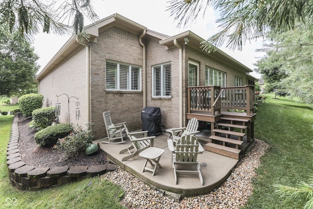 1454 Heron Ridge Blvd, Greenwood, IN 46143 - rear view of house with a patio, a deck, brick siding, a lawn, and stairs