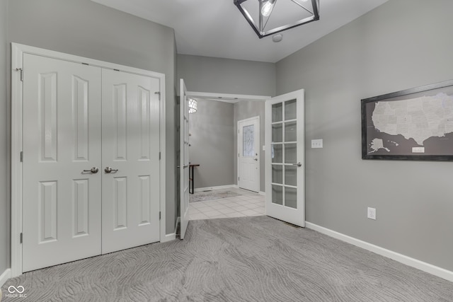 1454 Heron Ridge Blvd, Greenwood, IN 46143 - unfurnished bedroom featuring french doors, a closet, and carpet flooring