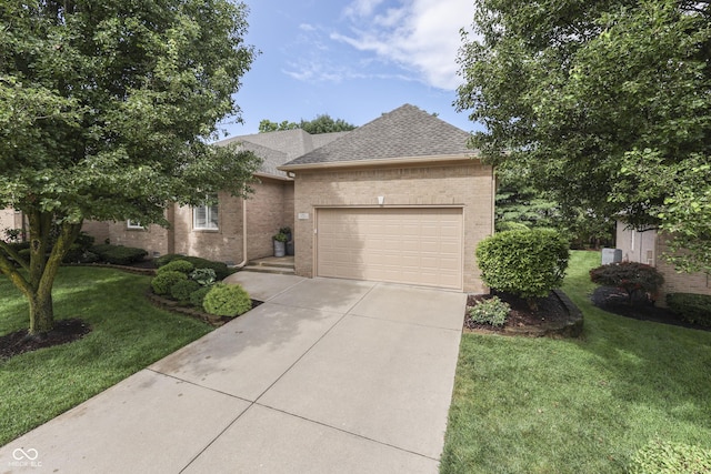 1454 Heron Ridge Blvd, Greenwood, IN 46143 - view of front facade with concrete driveway, a garage, brick siding, a shingled roof, and a front yard