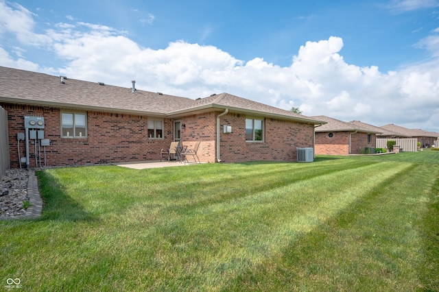 114 Asbury Dr, Anderson, IN 46013 - rear view of property with a patio area, brick siding, a yard, and a shingled roof