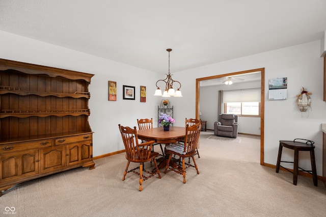 114 Asbury Dr, Anderson, IN 46013 - dining area featuring light carpet, a chandelier, and a ceiling fan
