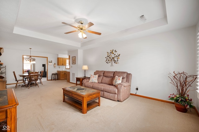 114 Asbury Dr, Anderson, IN 46013 - living room with a raised ceiling, light colored carpet, and ceiling fan