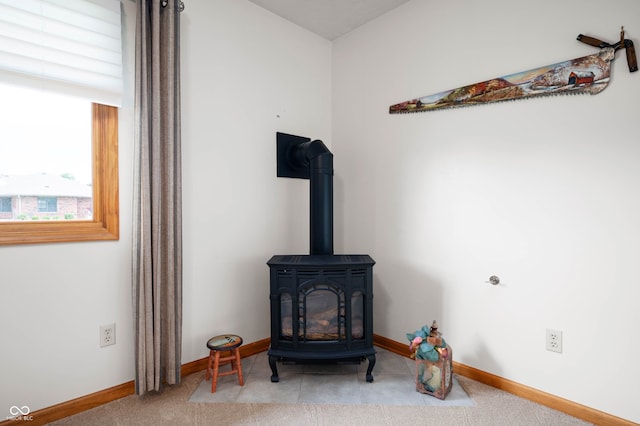 114 Asbury Dr, Anderson, IN 46013 - detailed view of a wood stove and carpet flooring