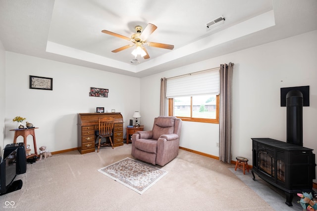 114 Asbury Dr, Anderson, IN 46013 - sitting room with a raised ceiling, ceiling fan, carpet, and a wood stove