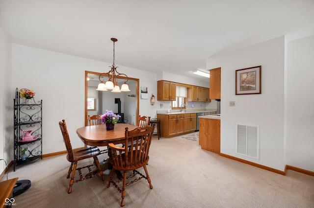 114 Asbury Dr, Anderson, IN 46013 - dining space featuring a chandelier, light colored carpet, and plenty of natural light