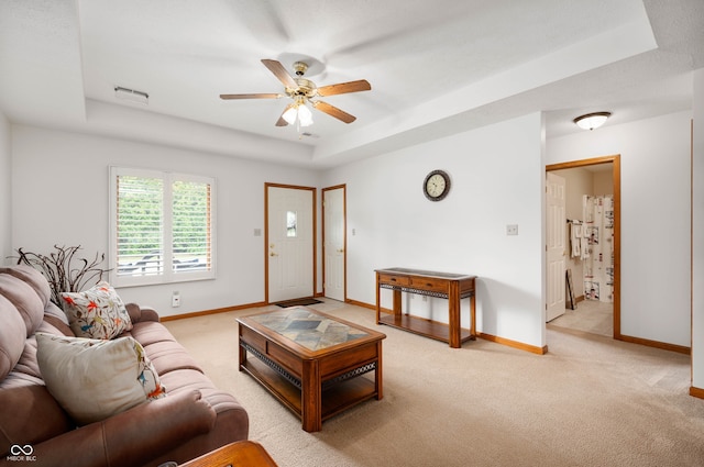 114 Asbury Dr, Anderson, IN 46013 - living room featuring a raised ceiling, light colored carpet, and ceiling fan