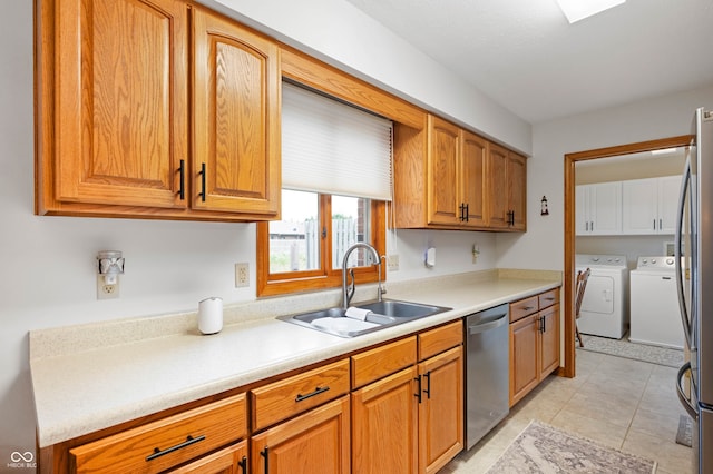 114 Asbury Dr, Anderson, IN 46013 - kitchen with washing machine and clothes dryer, stainless steel appliances, light countertops, and brown cabinets