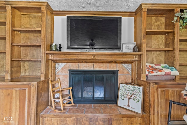 6092 N Jack Morgan Rd, Austin, IN 47102 - detailed view of built in features, a tiled fireplace, and a textured ceiling