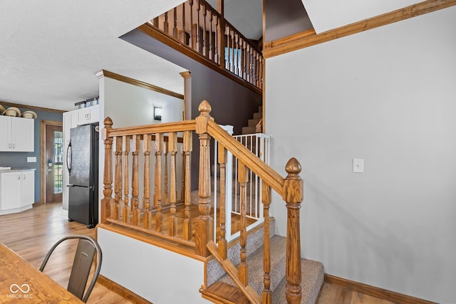 6092 N Jack Morgan Rd, Austin, IN 47102 - staircase with crown molding, wood finished floors, and a textured ceiling