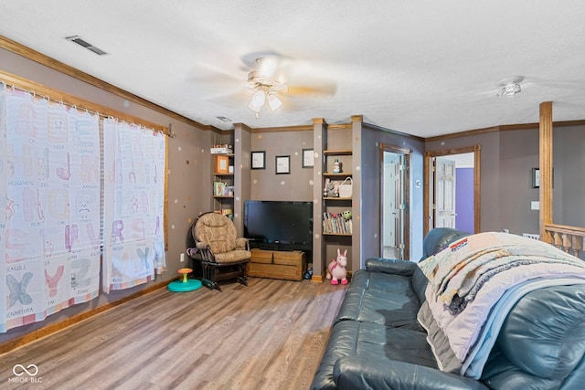 6092 N Jack Morgan Rd, Austin, IN 47102 - living area featuring wood finished floors, ceiling fan, and crown molding