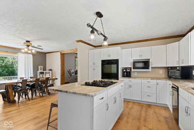 6092 N Jack Morgan Rd, Austin, IN 47102 - kitchen featuring black appliances, a textured ceiling, crown molding, white cabinetry, and a kitchen island