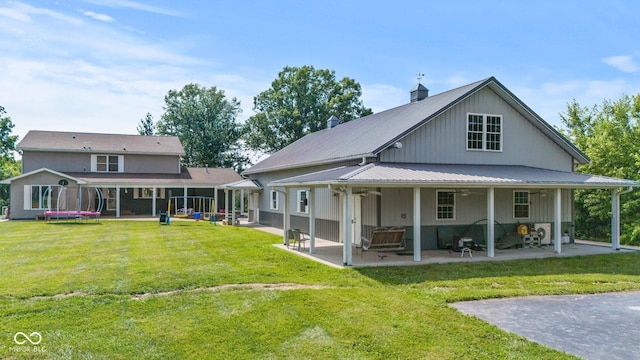 6092 N Jack Morgan Rd, Austin, IN 47102 - rear view of property with a ceiling fan, a patio, a lawn, and a metal roof