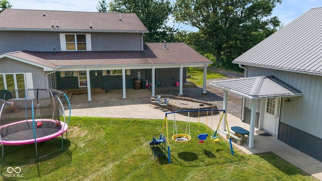 6092 N Jack Morgan Rd, Austin, IN 47102 - back of house featuring a trampoline, a patio, a yard, and a playground