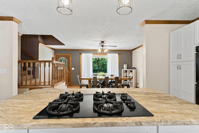 6092 N Jack Morgan Rd, Austin, IN 47102 - kitchen with black gas cooktop, a textured ceiling, ornamental molding, white cabinetry, and ceiling fan