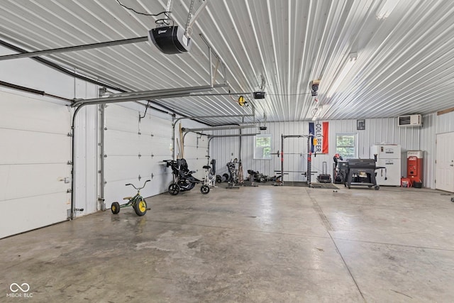 6092 N Jack Morgan Rd, Austin, IN 47102 - garage with a garage door opener and a wall mounted air conditioner