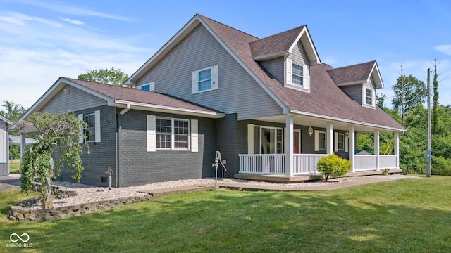 6092 N Jack Morgan Rd, Austin, IN 47102 - view of front of home featuring a porch, a front yard, brick siding, and a shingled roof