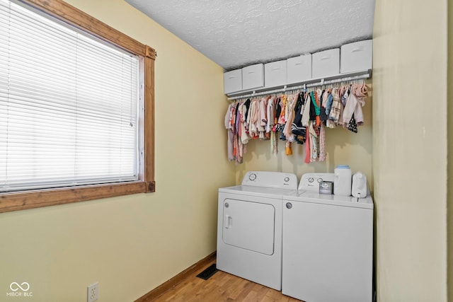 6092 N Jack Morgan Rd, Austin, IN 47102 - laundry room with washing machine and clothes dryer, a textured ceiling, and light wood-style flooring
