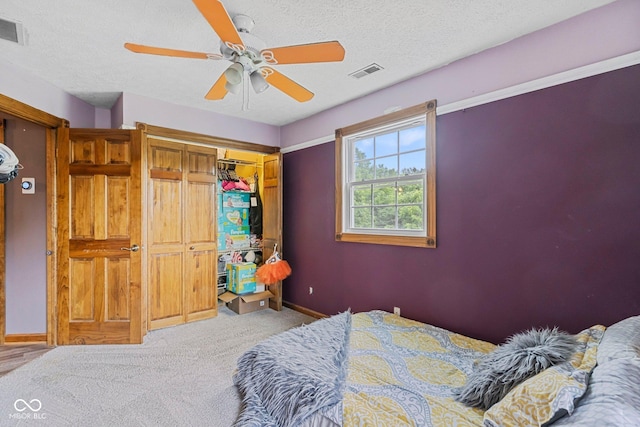 6092 N Jack Morgan Rd, Austin, IN 47102 - bedroom with carpet flooring, a textured ceiling, a closet, and ceiling fan