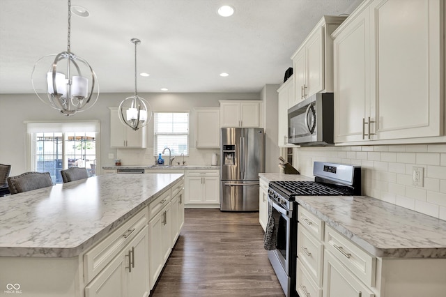 4596 Peabody Way, Westfield, IN 46062 - kitchen with stainless steel appliances, a kitchen island, white cabinets, tasteful backsplash, and recessed lighting