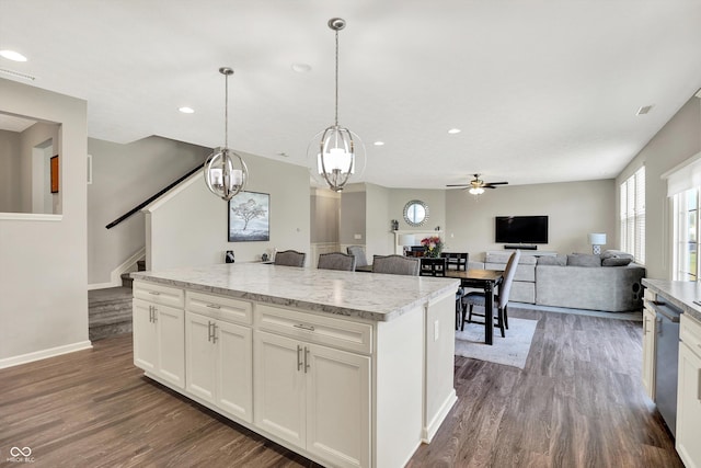 4596 Peabody Way, Westfield, IN 46062 - kitchen featuring dark wood-style flooring, a kitchen island, a ceiling fan, white cabinets, and pendant lighting