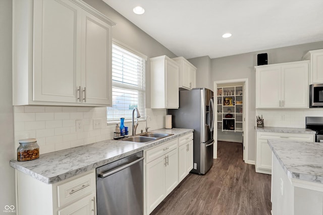 4596 Peabody Way, Westfield, IN 46062 - kitchen with stainless steel appliances, dark wood-style floors, white cabinets, decorative backsplash, and recessed lighting