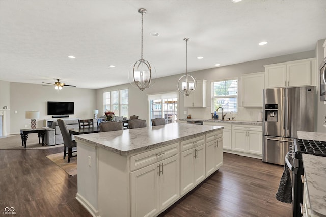 4596 Peabody Way, Westfield, IN 46062 - kitchen with appliances with stainless steel finishes, dark wood-style flooring, recessed lighting, ceiling fan, and a center island