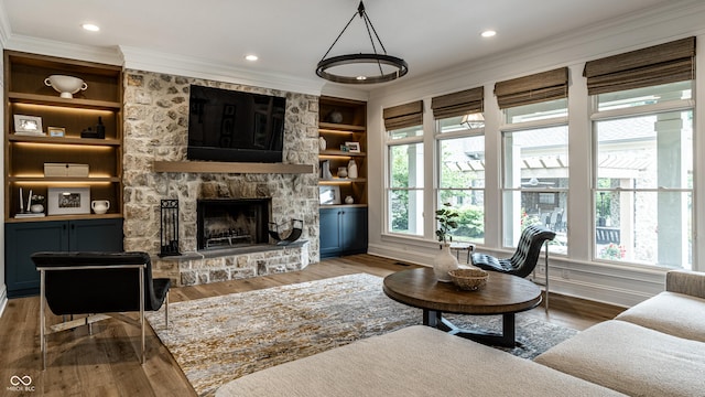 9681 Pleasant View Ln, Zionsville, IN 46077 - living room with healthy amount of natural light, crown molding, wood finished floors, built in shelves, and recessed lighting