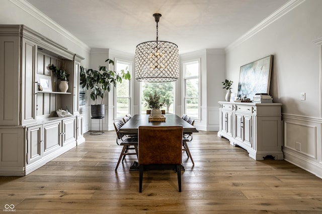 9681 Pleasant View Ln, Zionsville, IN 46077 - dining space featuring a decorative wall, crown molding, wood finished floors, and wainscoting