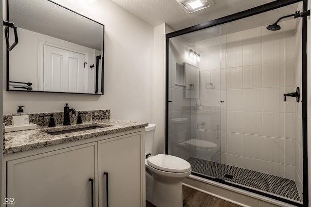 9681 Pleasant View Ln, Zionsville, IN 46077 - full bathroom featuring vanity, a shower stall, wood finished floors, and a textured ceiling