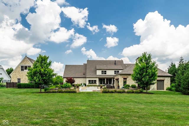 9681 Pleasant View Ln, Zionsville, IN 46077 - rear view of property with a yard, a patio, a garage, and stone siding