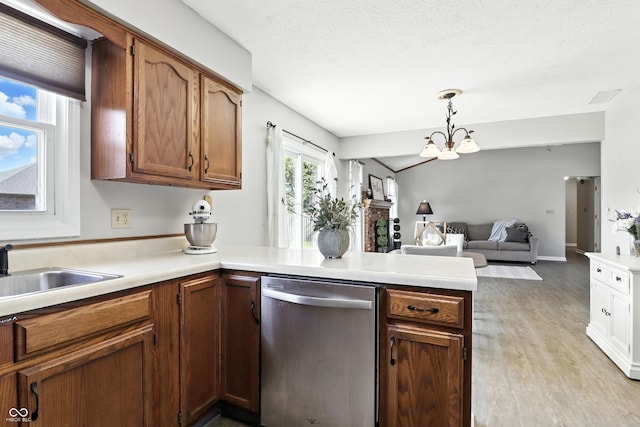 1011 Stevedon Ct, Plainfield, IN 46168 - kitchen featuring stainless steel dishwasher, a peninsula, open floor plan, light countertops, and light wood-style flooring