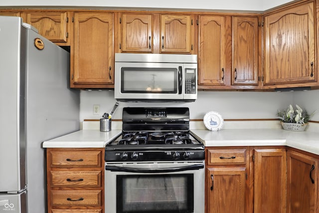 1011 Stevedon Ct, Plainfield, IN 46168 - kitchen with appliances with stainless steel finishes, light countertops, and brown cabinets