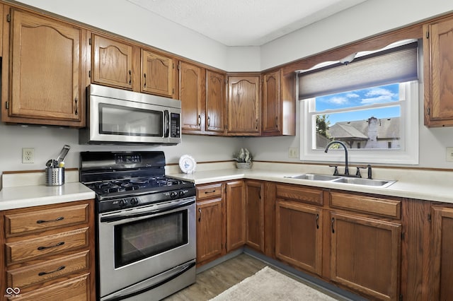 1011 Stevedon Ct, Plainfield, IN 46168 - kitchen featuring stainless steel appliances, brown cabinets, and light countertops