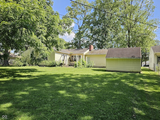 2024 E 41st St, Anderson, IN 46013 - rear view of property with a yard and a chimney