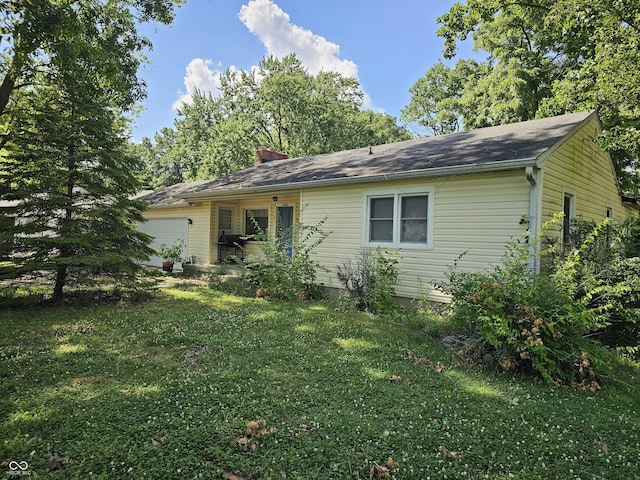 2024 E 41st St, Anderson, IN 46013 - view of front of home with a garage, a front lawn, and a chimney
