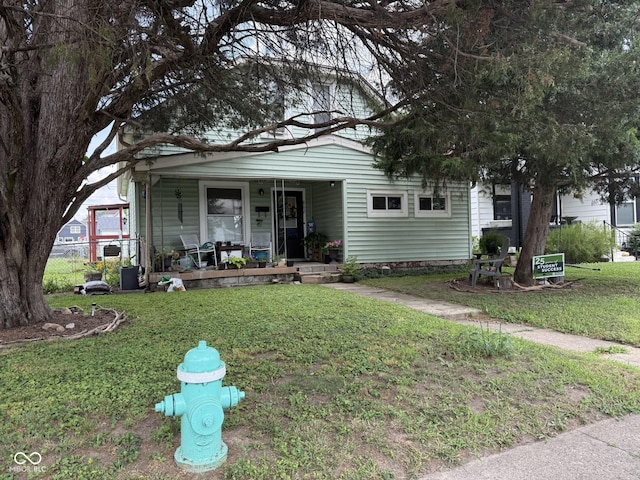 802 Weghorst St, Indianapolis, IN 46203 - view of front of house with a porch and a front yard
