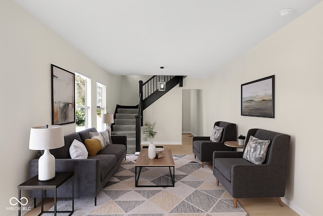 living area featuring stairs and wood finished floors