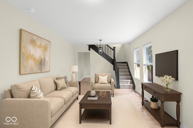 living room featuring stairway and light wood finished floors