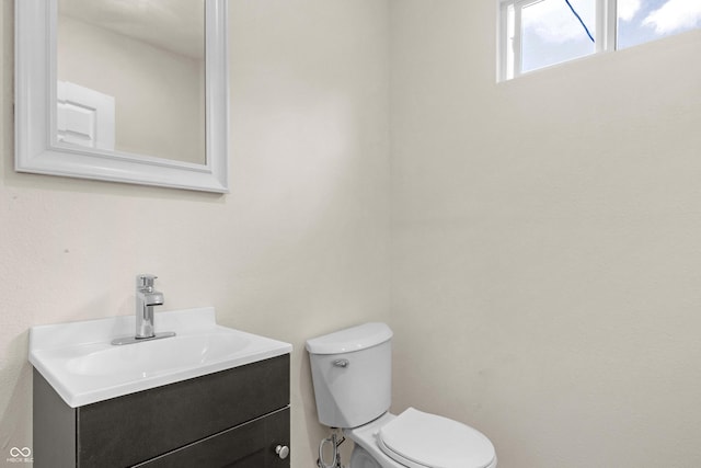 bathroom featuring toilet and vanity