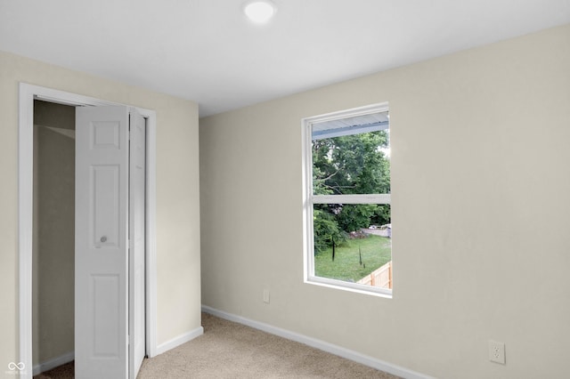 unfurnished bedroom with baseboards and carpet