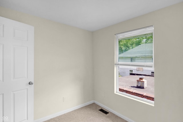 carpeted spare room with baseboards