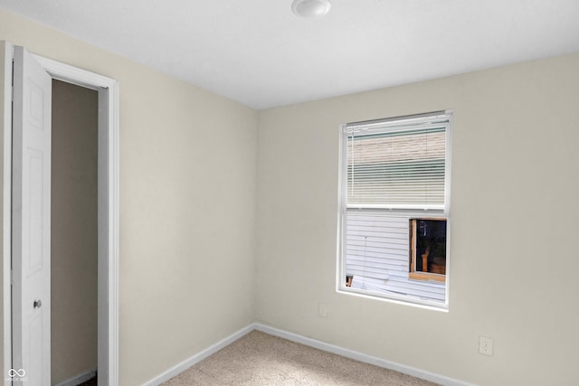 unfurnished bedroom featuring carpet and baseboards