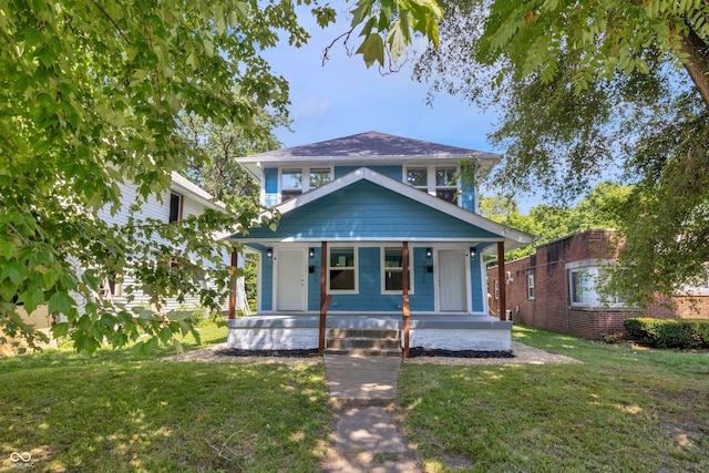 view of front of home with a front yard and a porch