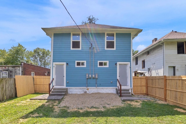 back of house with entry steps and a fenced backyard