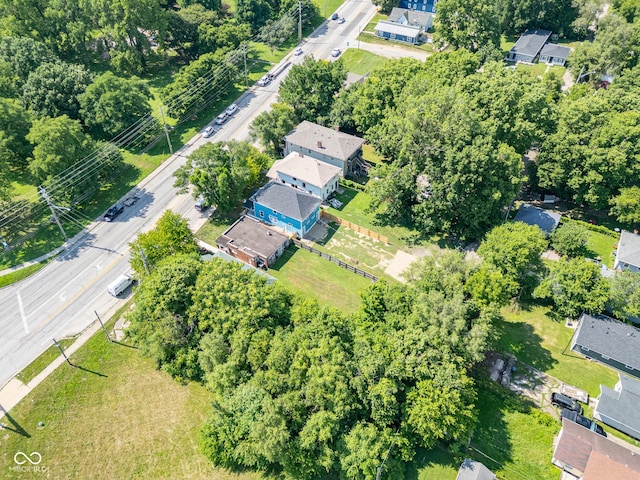 aerial overview of property's location featuring a tree filled landscape