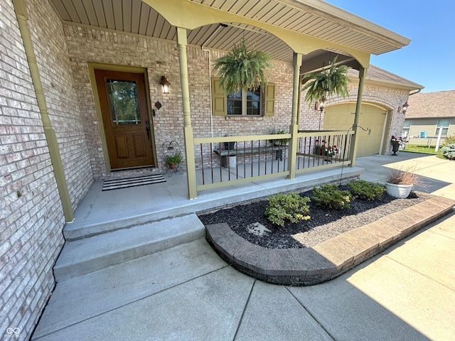 2080 Galway Trl N, Madison, IN 47250 - doorway to property featuring covered porch, brick siding, an attached garage, and concrete driveway