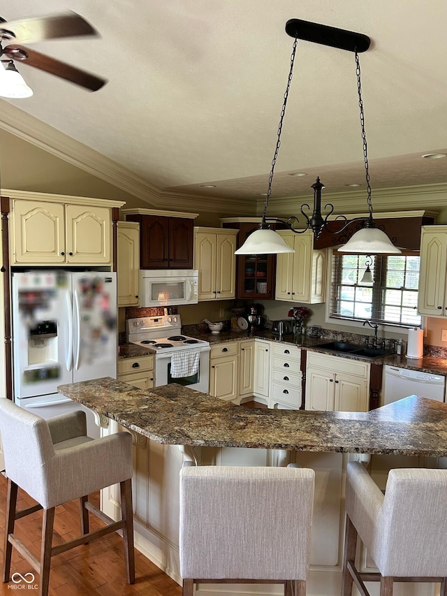 2080 Galway Trl N, Madison, IN 47250 - kitchen with white appliances, ornamental molding, a kitchen bar, pendant lighting, and vaulted ceiling